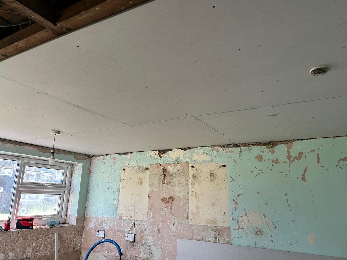 Ceiling reboarded and walls stripped back during a full refurbishment